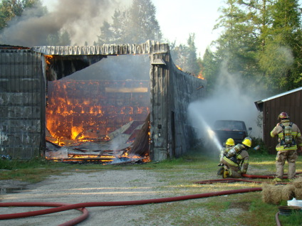 Photo of firefighters suppressing a garage fire