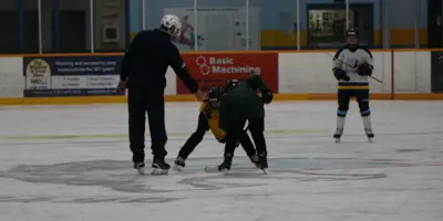 Ice surface in the Dryden Memorial Arena with players ready for the puck to drop.
